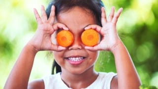 asian girl having fun to learn about vegetables with happiness